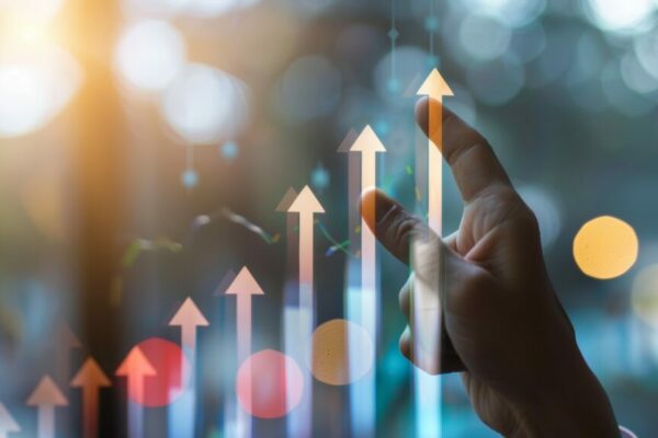 Hand pointing at upward arrow graph, symbolizing growth, success, and positive trends in business or finance.